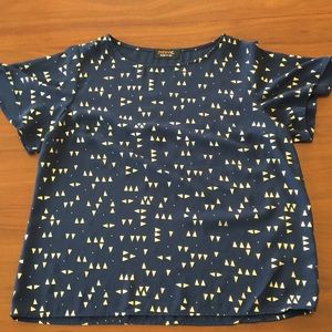 navy blue shirt with gold accents